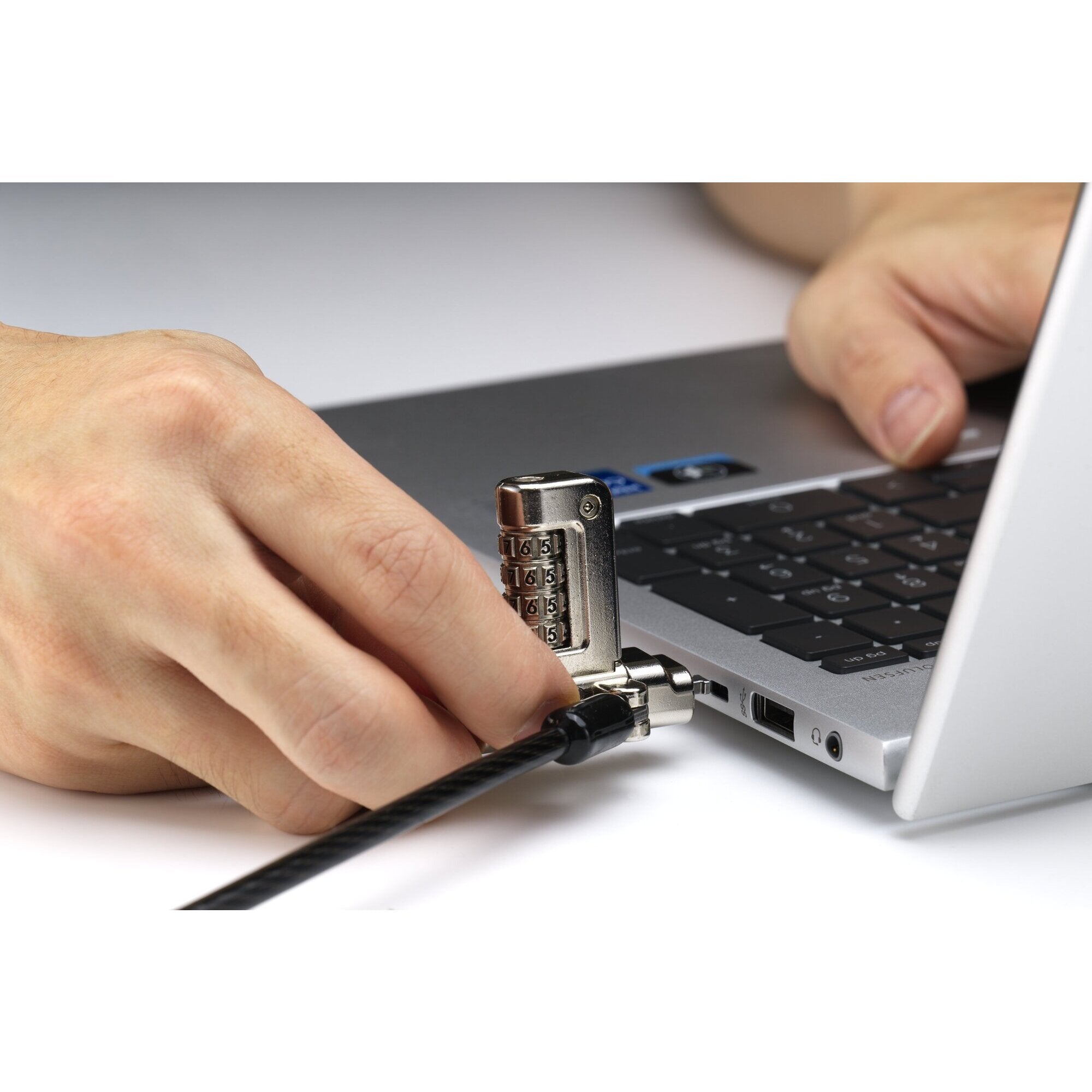 Angled detail of the serialised Kensington 3-in-1 lock head showing the slim profile that keeps adjacent laptop ports clear when the lock is fitted