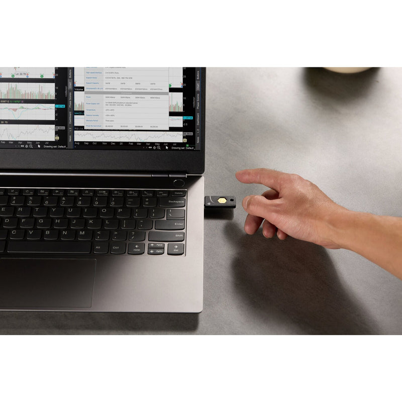 Kensington VeriMark NFC Plus security key shown in a workplace setting being used to sign in at a desktop computer