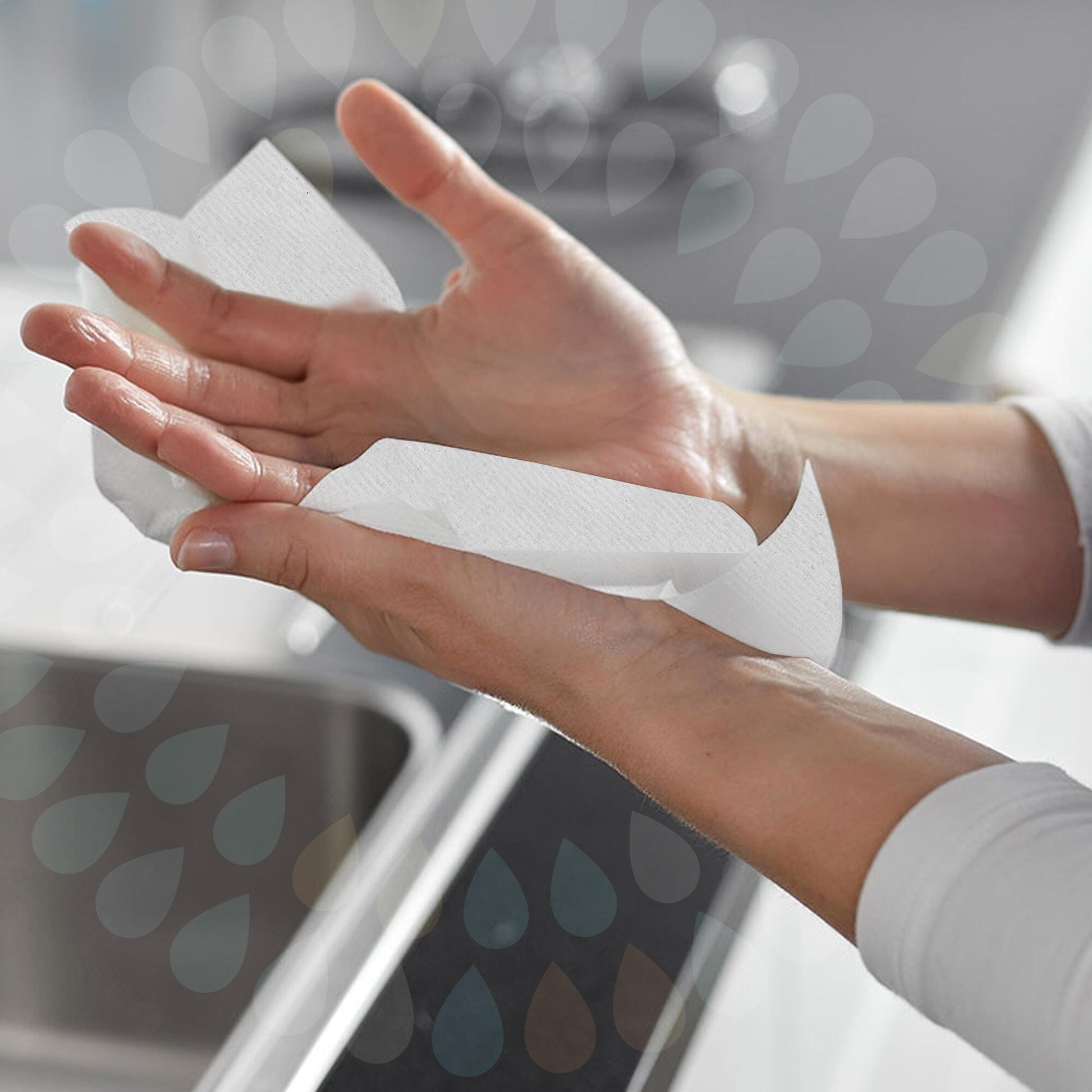 Close view of two wet hands being dried with a single white Kleenex compact hand towel at a washroom basin, showing the towel folded over the palm