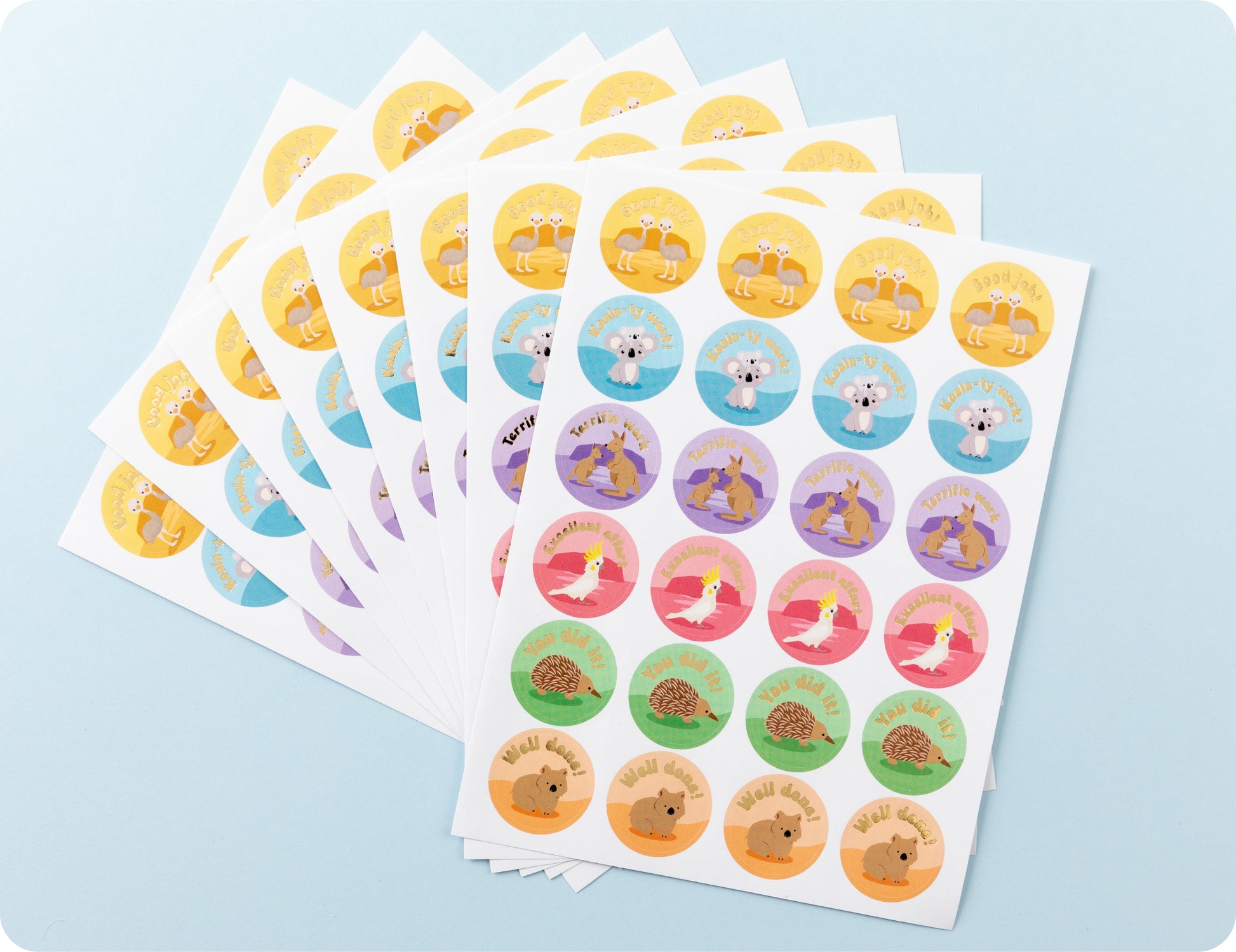 Sticker sheets from the Aussie Achievers book fanned out to show the individual animal designs and encouragement wording.
