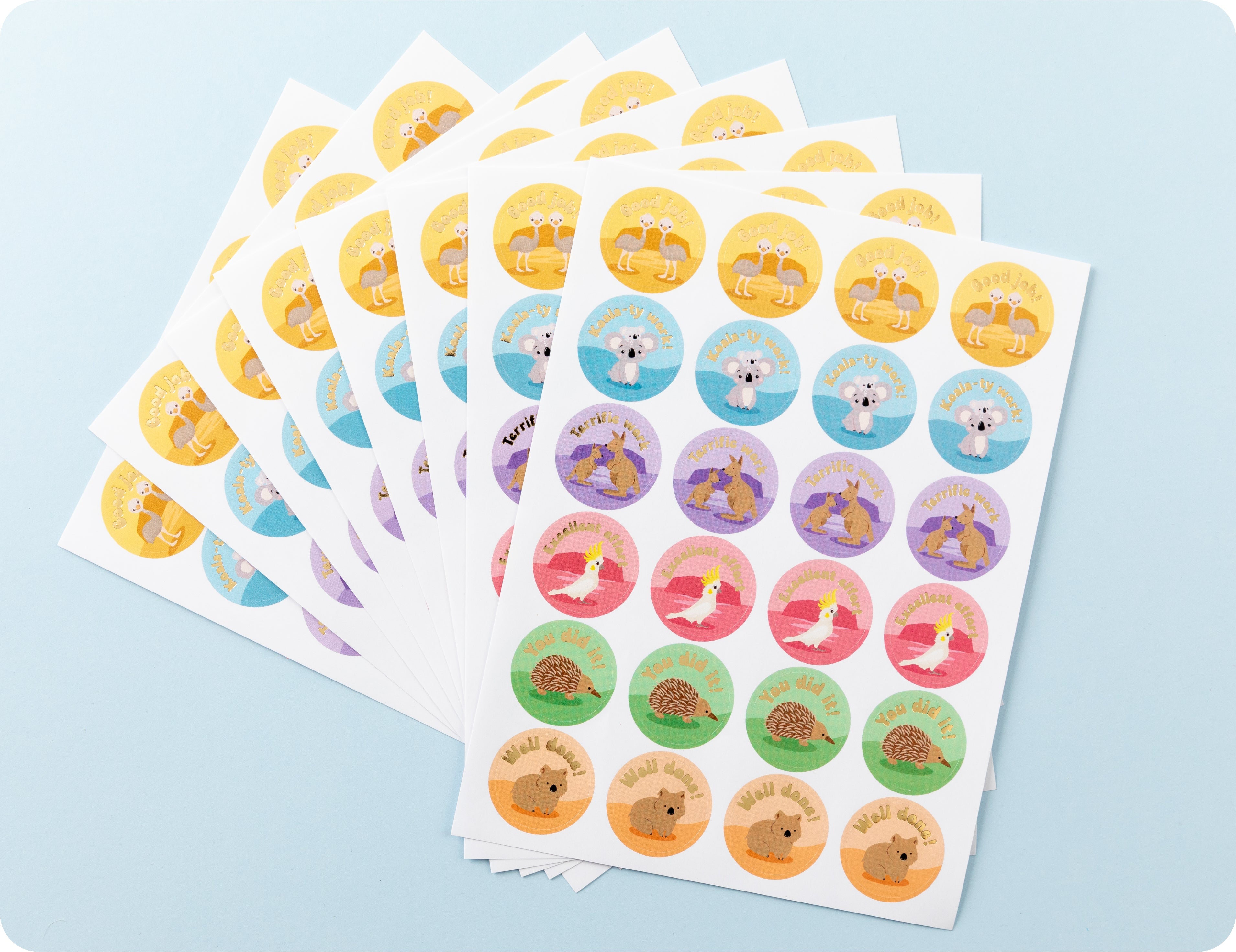 Sticker sheets from the Aussie Achievers book fanned out to show the individual animal designs and encouragement wording.