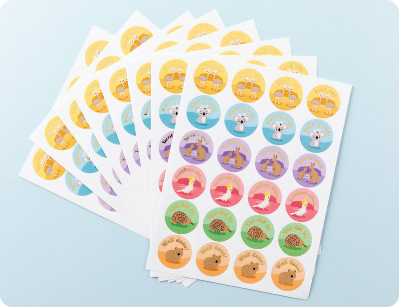 Sticker sheets from the Aussie Achievers book fanned out to show the individual animal designs and encouragement wording.