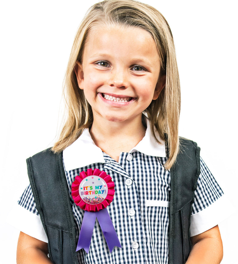 Second view of the pink birthday badge showing the confetti settled to one side and the printed design detail.