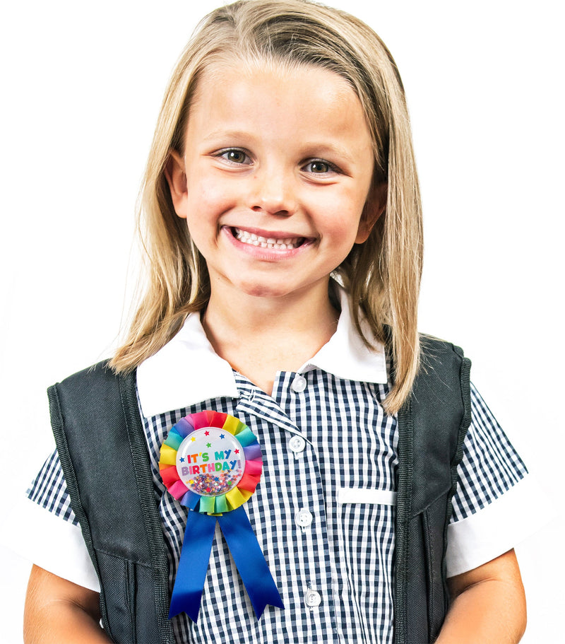 Second view of the rainbow birthday badge showing the confetti settled to one side and the printed design detail.