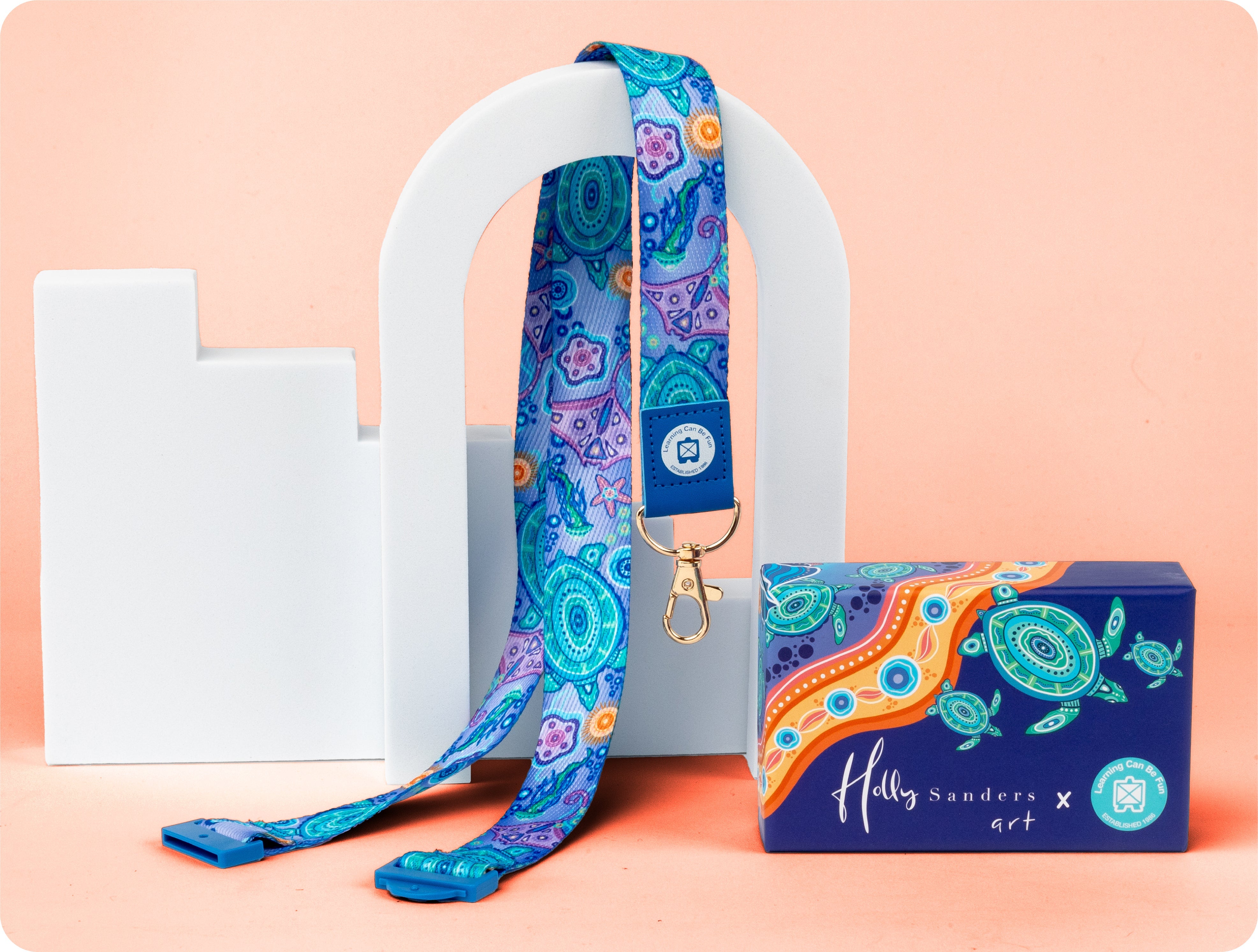 Ocean Country lanyard carrying First Nations artwork by Holly Sanders in ocean tones, shown flat with the clasp and safety breakaway clip visible.