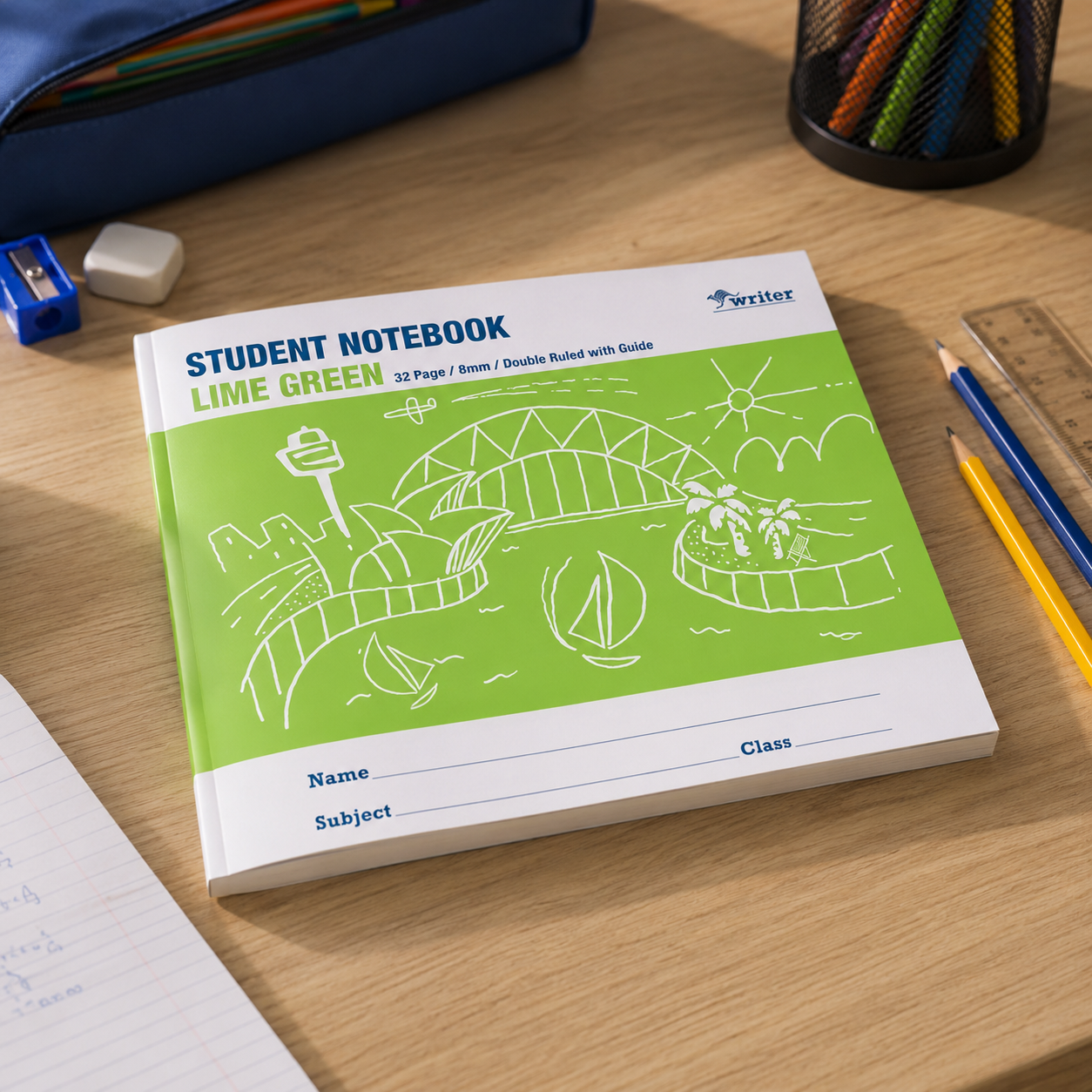 Lime green Writer student notebook on a wooden study desk with pencils, ruler, sharpener and pencil case for classroom writing practice.
