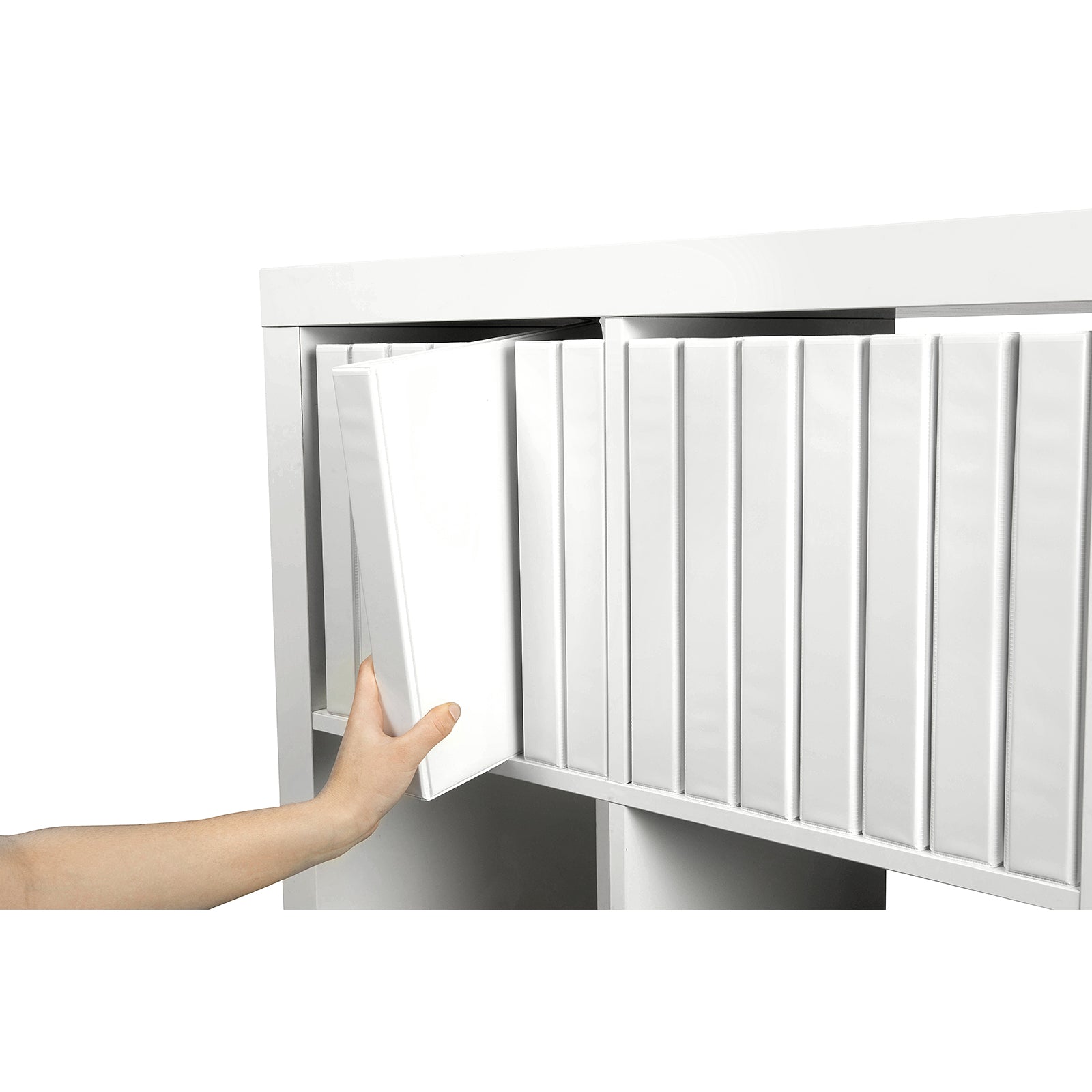 Hand placing the Marbig A4 White Clearview Binder into a shelving unit with matching binders, demonstrating efficient archive storage and organised document management.