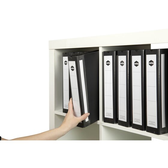 Hand pulling a black Marbig Deluxe binder from a white shelf lined with matching black binders and white spine labels
