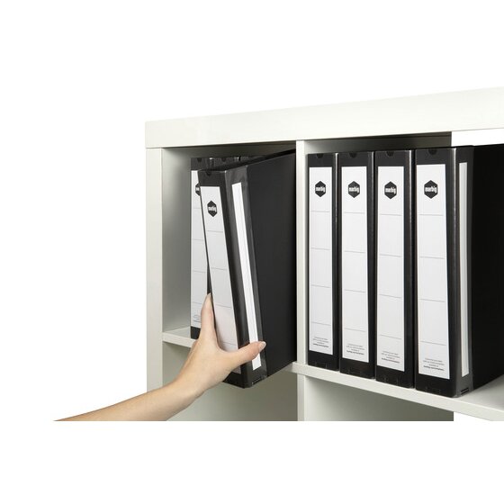 Hand drawing a black Marbig Deluxe binder from a white shelf of matching binders with labelled spines