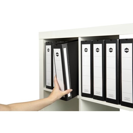 Hand pulling a deep black Marbig Deluxe binder from a white shelf of labelled black binders