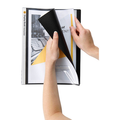 Hands turning back the black cover of a Marbig insert cover display book, a printed report page showing at the front