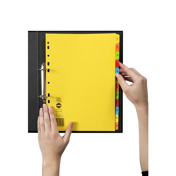 Hands turning a bright numbered tab on a Marbig 1 to 12 manilla divider set filed in a black 2 ring binder