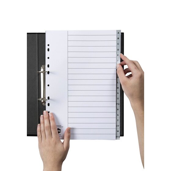 Hands turning to a lettered tab in a Marbig A to Z foolscap grey divider set held in a black ring binder
