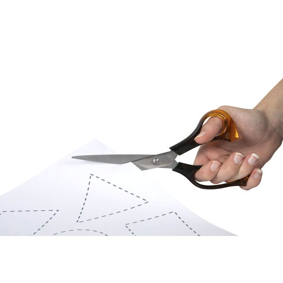 Hand cutting a dotted shape from white paper with long bladed Marbig Dura Sharp scissors with black and amber handles