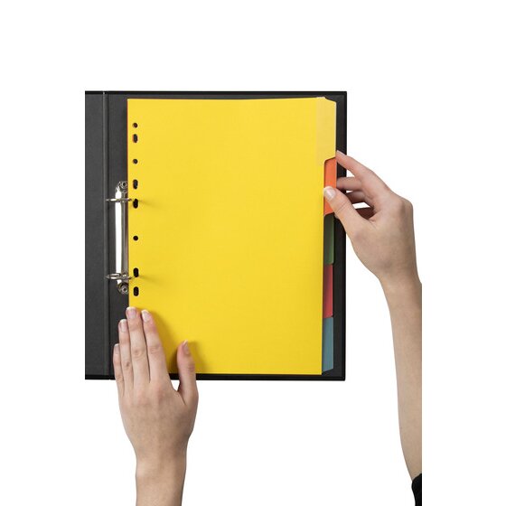 Hand turning a bright tab on Marbig Eraseable manilla dividers filed in a black A4 2 ring binder