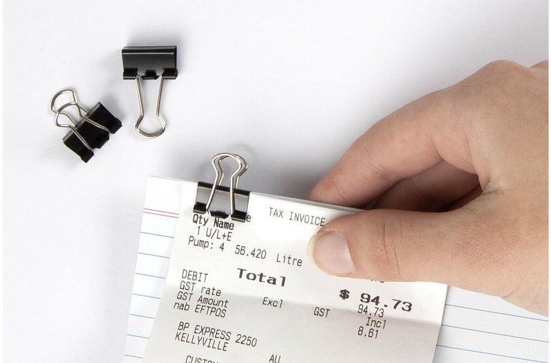 Marbig 15mm fold back clip in use holding a till receipt to a lined card, with two loose clips beside it