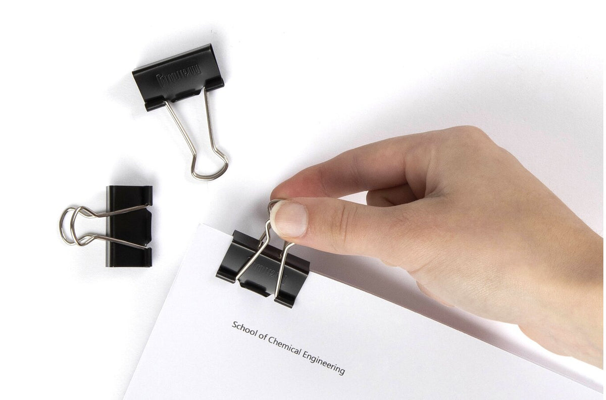 Marbig 32mm fold back clip in use fastening a document, with a hand fitting the clip and spare clips beside it