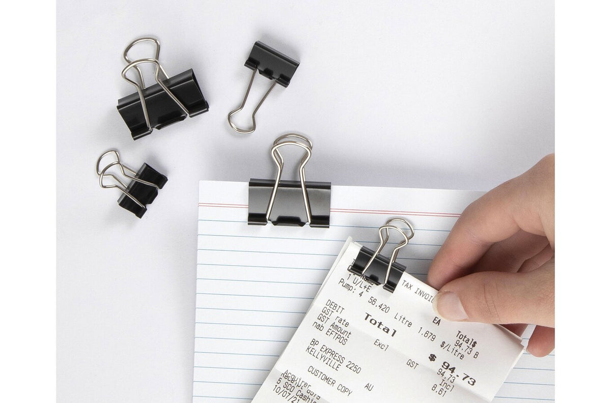 Marbig assorted fold back clips in use, a small clip holding a receipt to a lined card with larger clips beside it