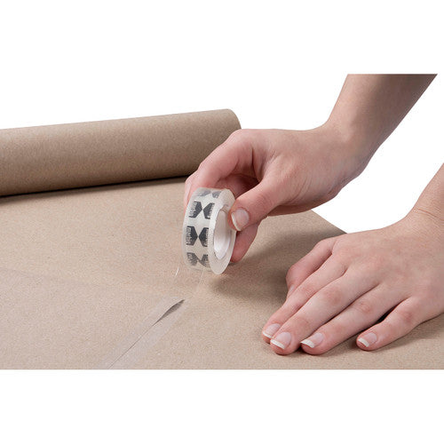 Hand rolling a Marbig clear tape roll along brown kraft paper to stick down a strip