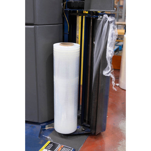 Roll of clear Marbig cast machine film loaded on the mast of a pallet wrapping machine, with film drawn up from the roll