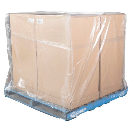 Close view of a clear plastic pallet bag covering cartons on a blue pallet, with the loose film gathered at the base