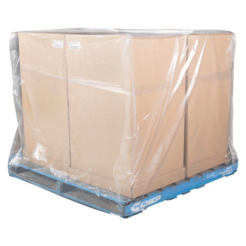 Clear plastic pallet bag covering a wide stack of brown cartons on a blue pallet, film gathered loosely at the base