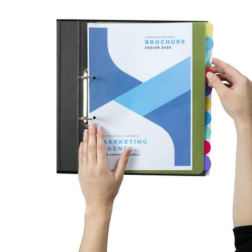 Hands turning a coloured extra wide View Tab divider past a printed brochure in a black A4 ring binder