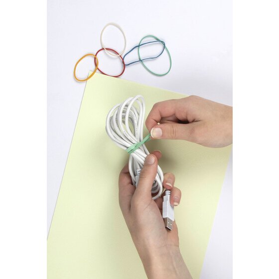 Hands looping a green rubber band around a coiled white cable, with red, yellow and blue bands resting on the sheet above