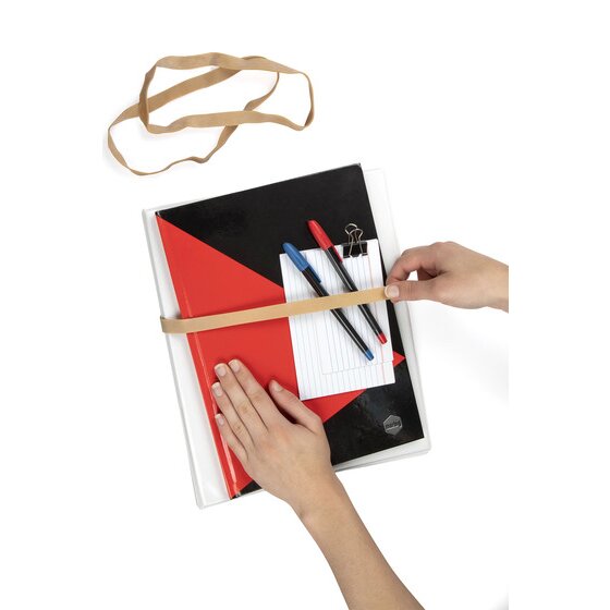 Hand stretching a broad natural rubber band around a black and red notebook holding pens and an index card