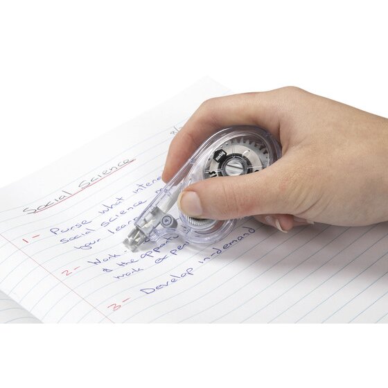 Hand running a Marbig Sidewinder correction tape along a line of handwriting on lined paper
