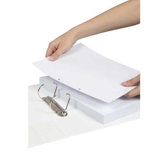 Hands placing a stack of two hole punched white paper onto the open D rings of a white Marbig binder