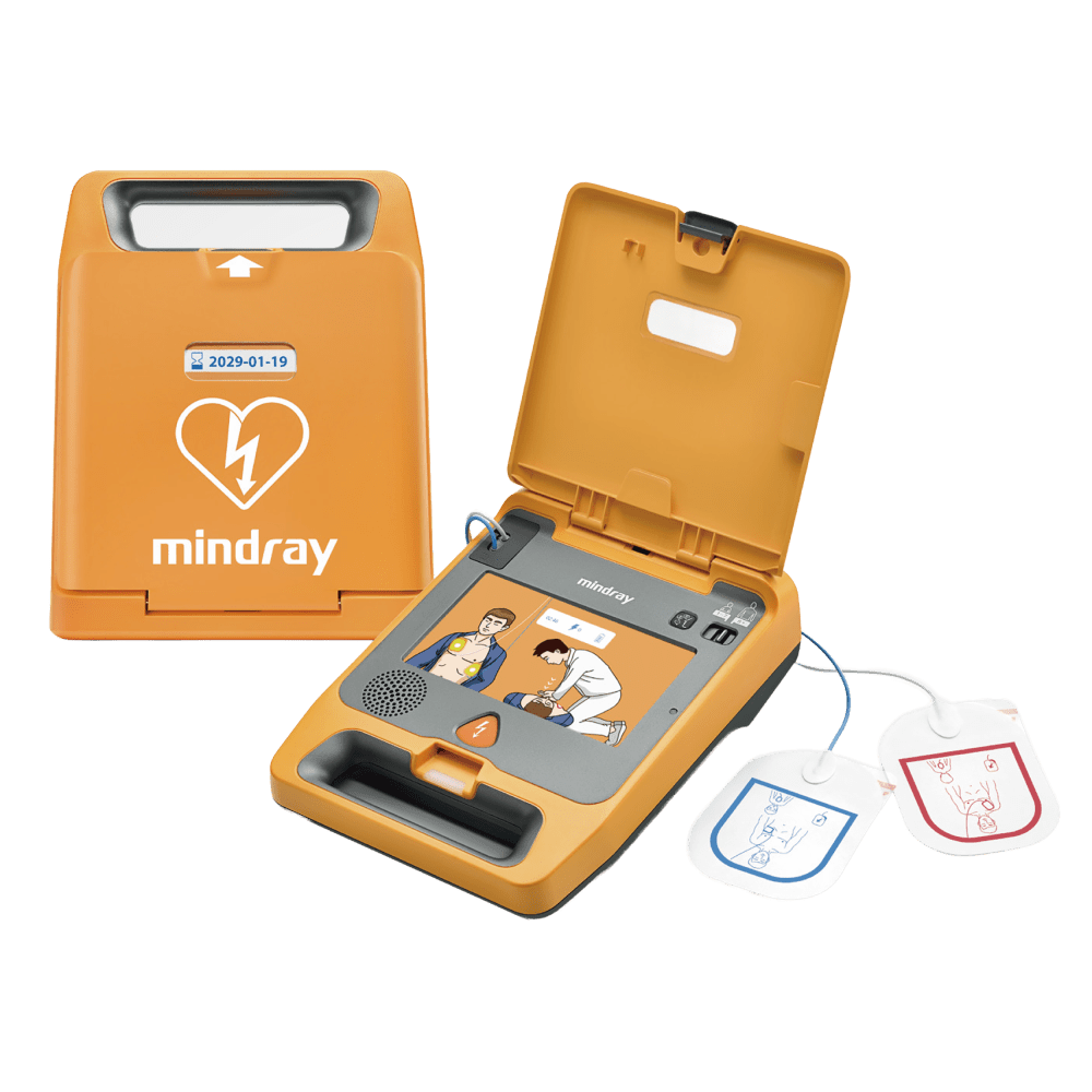 Mindray C1A defibrillator with the lid open, showing the instruction panel and connected electrode pads