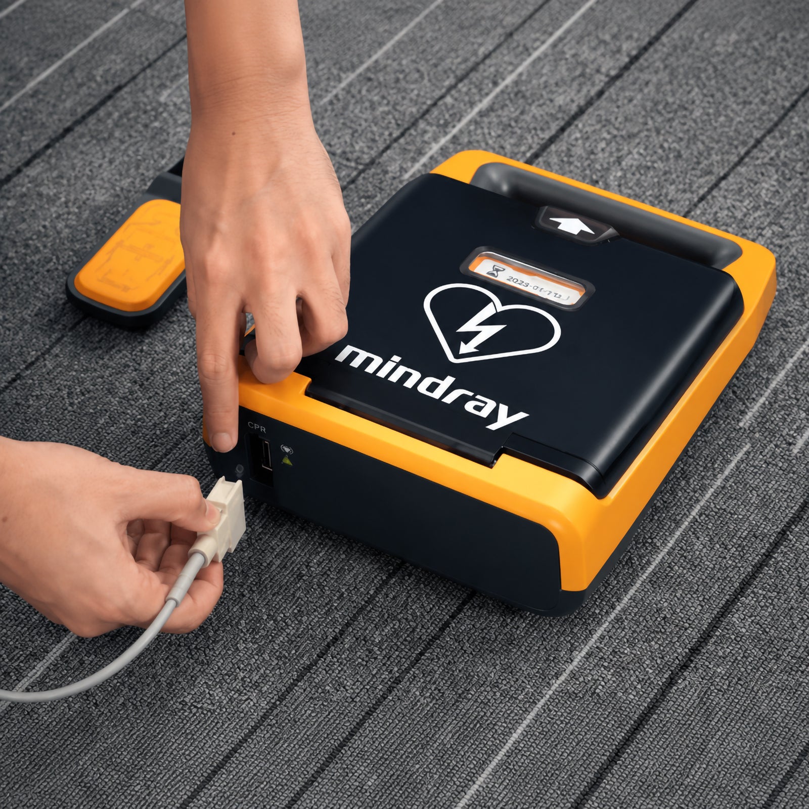 Mindray BeneHeart AED shown with its CPR sensor being connected to the dedicated CPR port. The close up training view demonstrates the wired sensor connection and compact AED design, helping users understand how the CPR feedback accessory integrates with a compatible Mindray defibrillator.