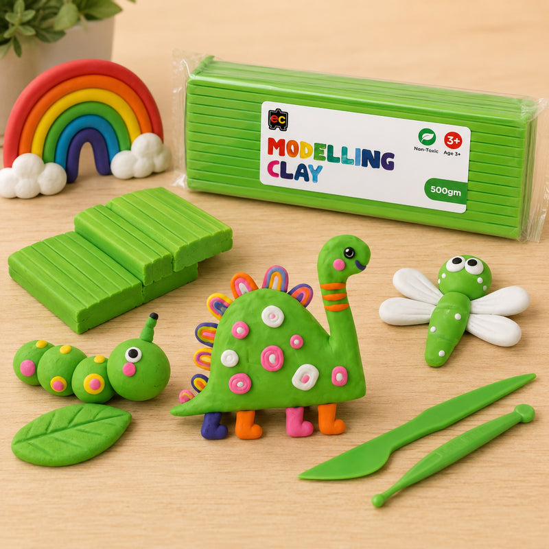Educational Colours Modelling Clay 500g Green with playful clay dinosaur and caterpillar figures, sculpting tools, and rainbow decoration on a clean wooden surface.