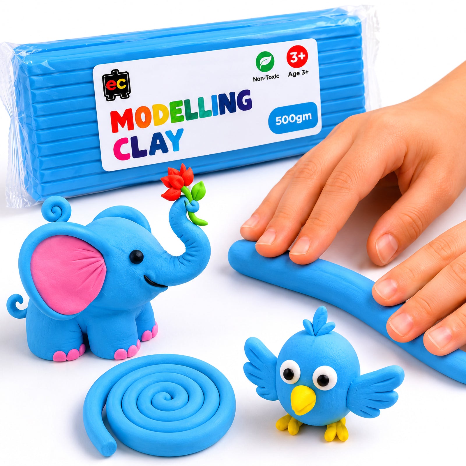 Hands shaping light blue modelling clay beside a 500g clay pack with cute handmade clay elephant, bird and spiral coil creations on a clean white background.