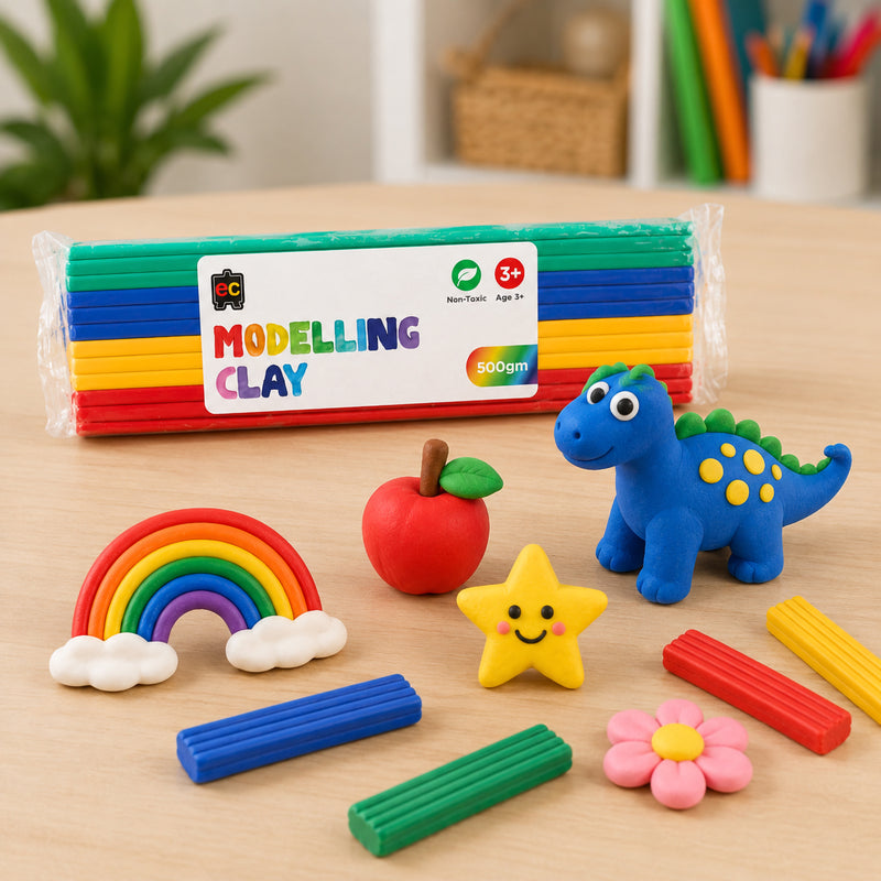 Colourful modelling clay pack with playful handmade clay shapes including a rainbow, smiling star, apple, flower, and dinosaur on a bright wooden tabletop.