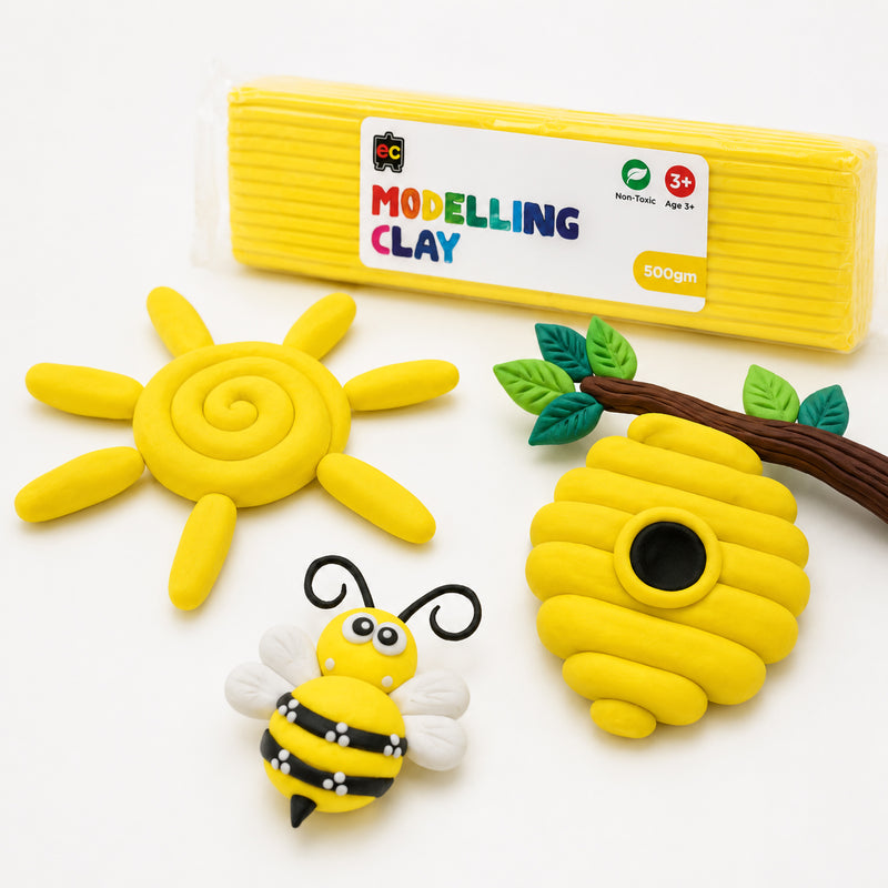 Educational Colours yellow modelling clay pack displayed with handmade clay bee, spiral sun and hanging bee hive on a clean white studio background.