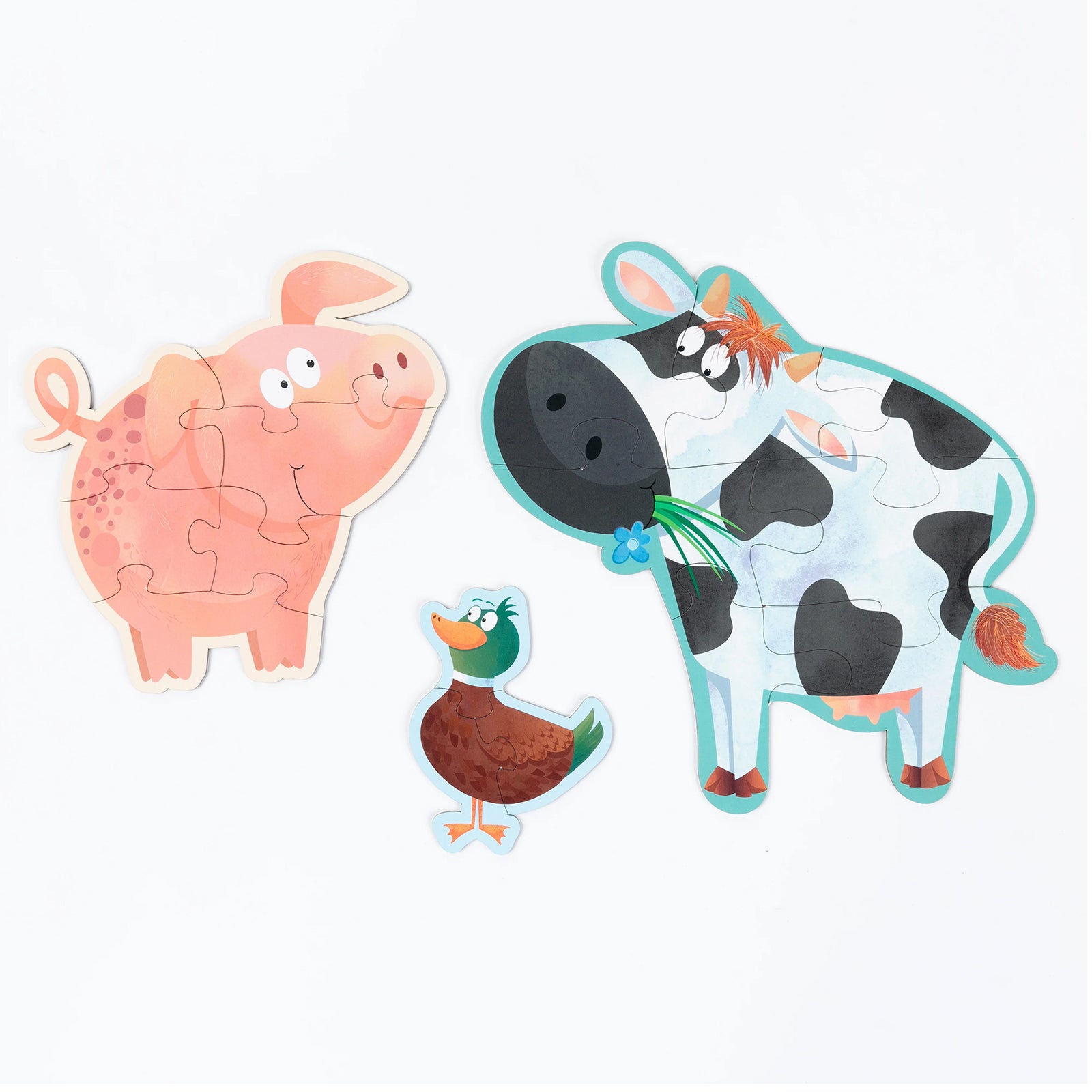 Pig, duck and cow shaped puzzles presented together on a neutral background, highlighting the large easy grip pieces, colourful artwork and progressive puzzle design suitable for early learners.