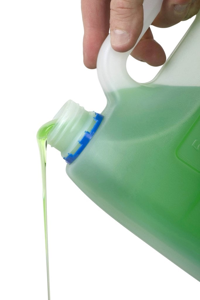 Green Northfork dishwashing liquid pouring from the 5 litre container, one of a carton of 3