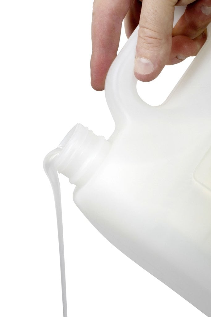 Pearl white Northfork hand and body wash being poured from the 5 litre container