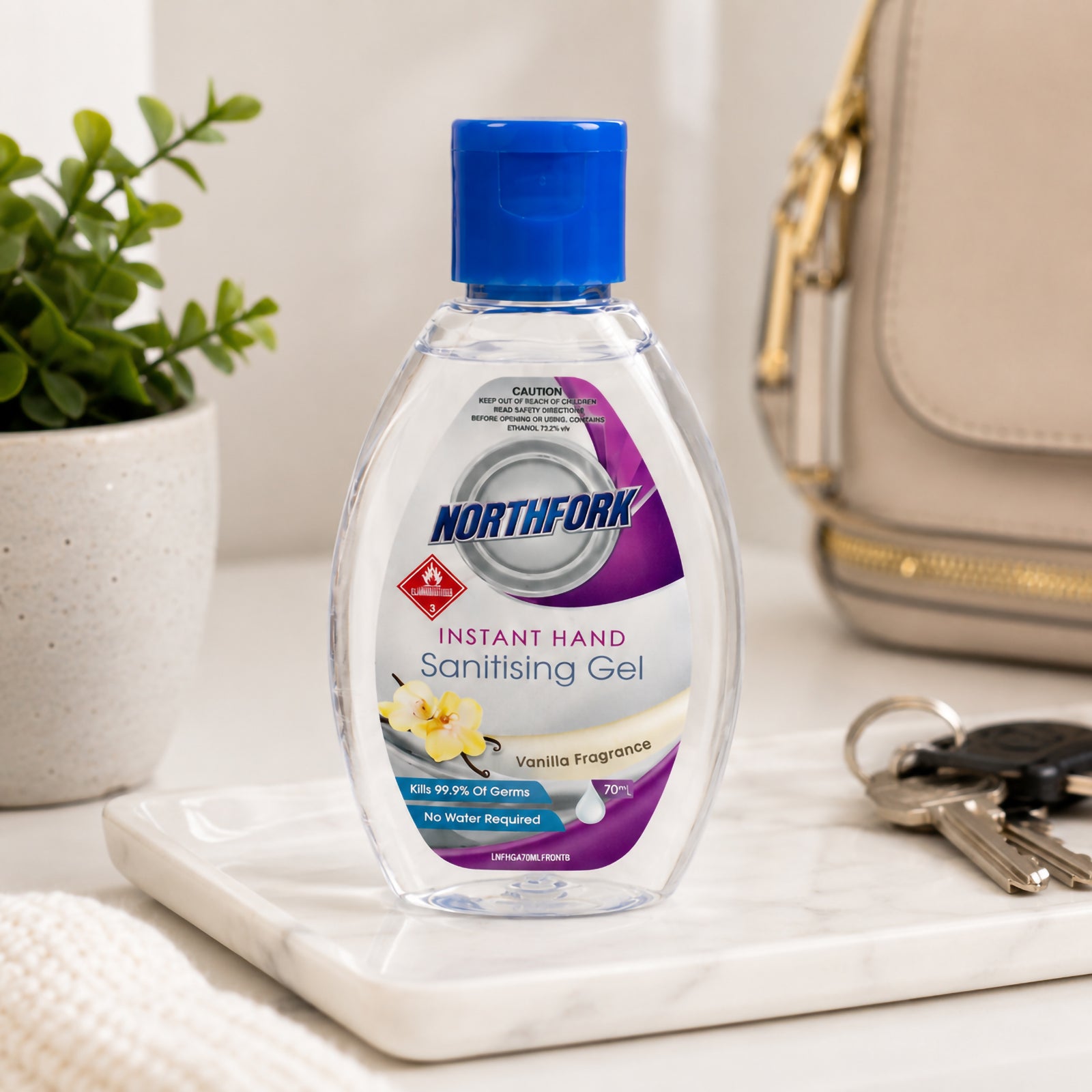 Northfork Instant Hand Sanitising Gel 70ml displayed on a marble tray beside a handbag, keys and decorative plant. The lifestyle scene highlights the portable bottle as a convenient hygiene solution for work, shopping and daily outings.