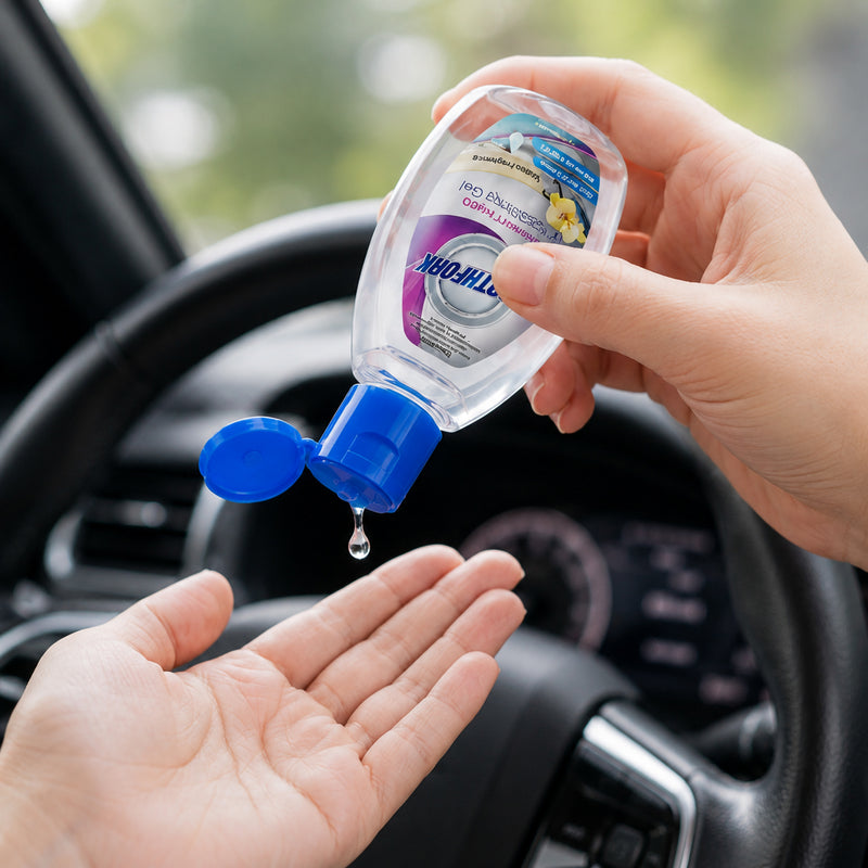 Northfork Instant Hand Sanitising Gel 70ml being dispensed into a person's hand while seated inside a vehicle. The compact bottle demonstrates convenient hand hygiene on the go, making it ideal for commuting, travel and everyday personal protection.
