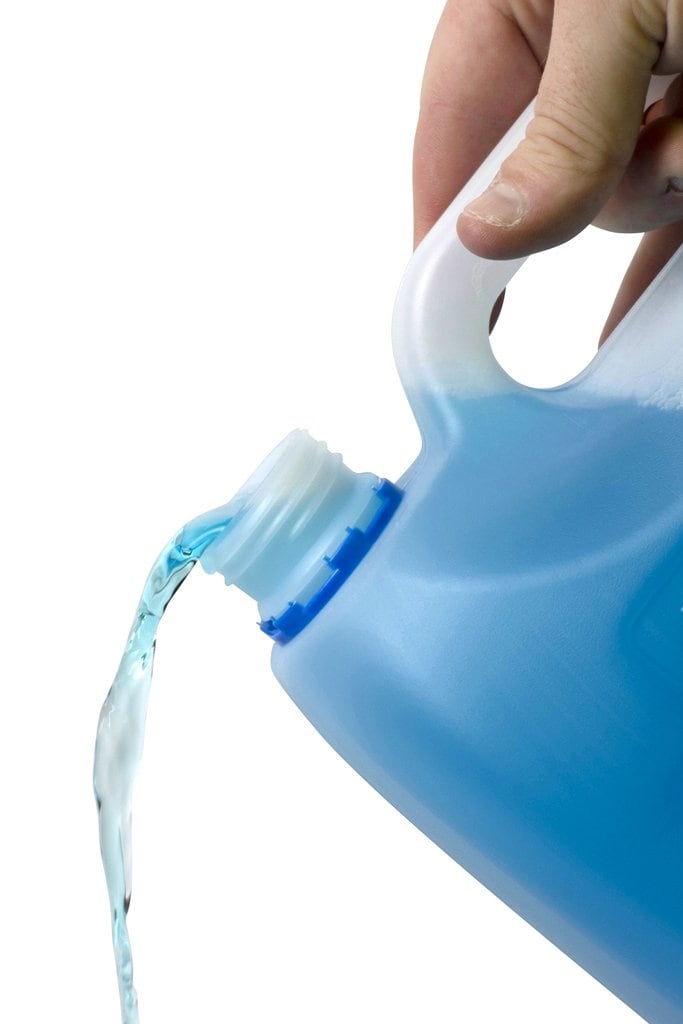 Pouring Northfork Window and Glass Cleaner from the 5 litre bottle