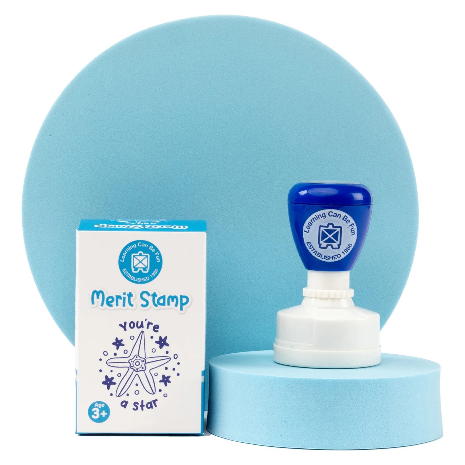 Ocean Country Starfish Merit Stamp and retail box presented on a soft blue display platform. The image emphasises the premium presentation, cultural artwork inspiration and educational purpose of this teacher reward stamp.