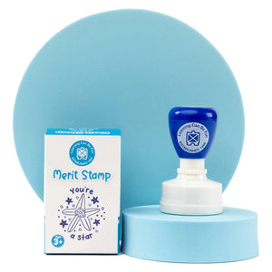 Ocean Country Starfish Merit Stamp and retail box presented on a soft blue display platform. The image emphasises the premium presentation, cultural artwork inspiration and educational purpose of this teacher reward stamp.