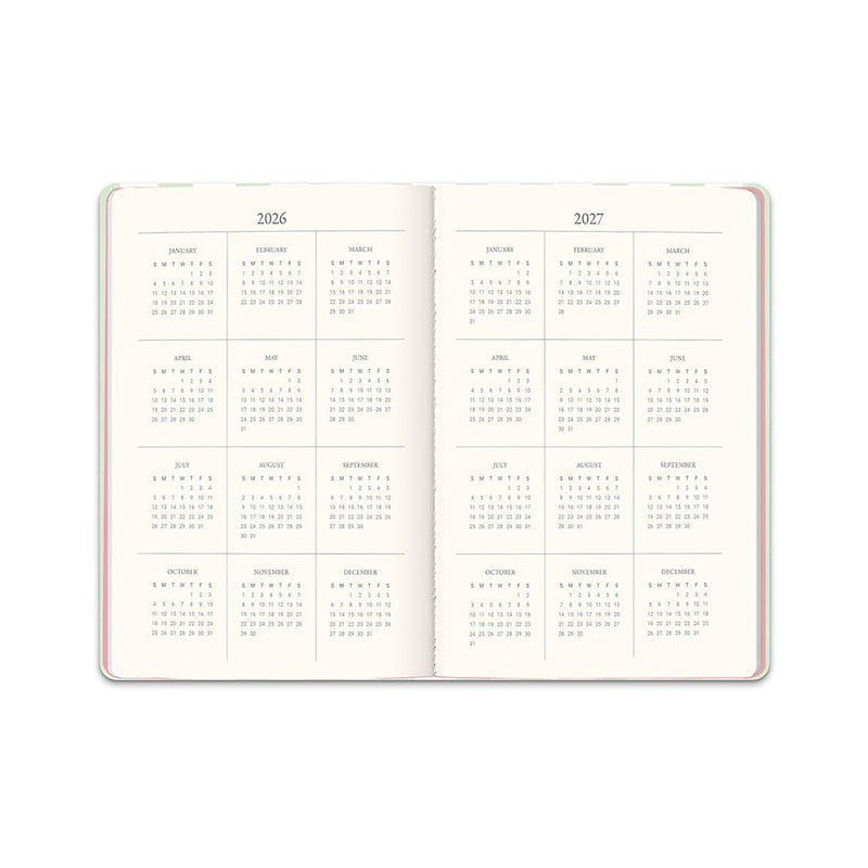 Orange Circle 2027 Casebound Diary 143 x 205mm Month To View Cabana Stripes shown from a second angle, the Cabana Stripes design, a crisp vertical stripe in soft coastal tones, with the spine and page block edge visible.