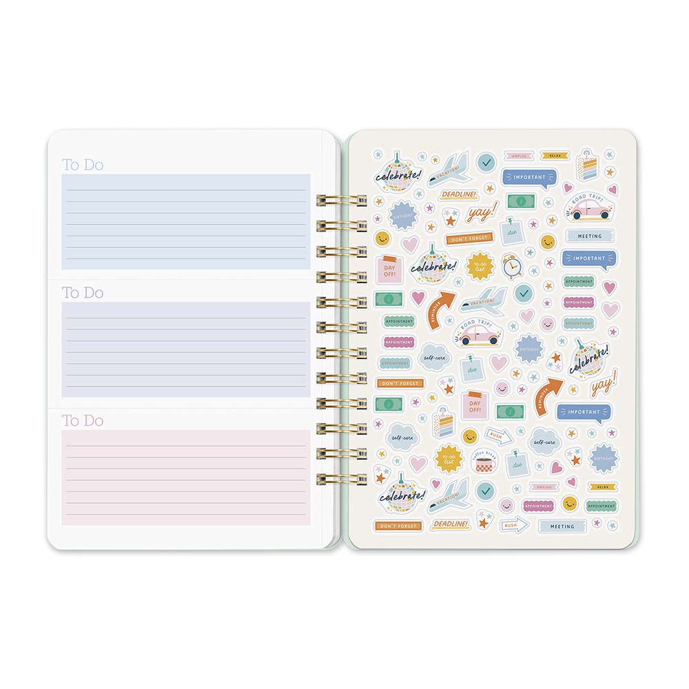 Orange Circle 2027 Do-It-All Diary 146 x 210mm Week To View Fruit And Flora shown from a further angle, the Fruit And Flora design, a bright botanical mix of fruit and flowers, showing the cover corners and closure detail.