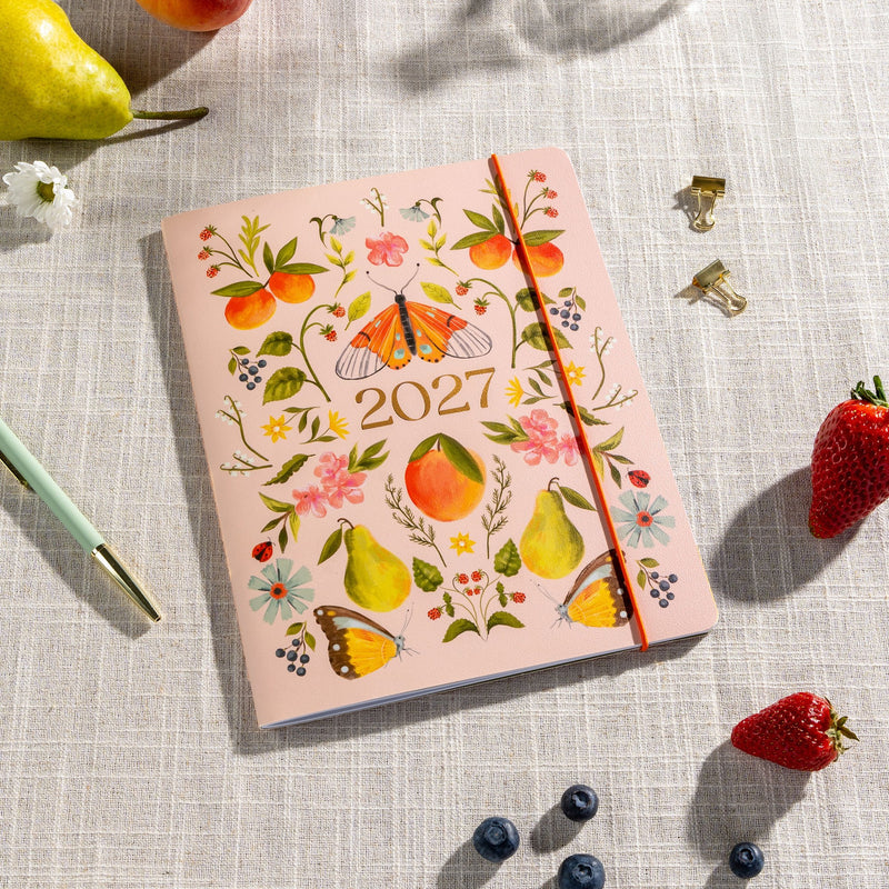 Orange Circle 2027 Just Right Diary 191 x 248mm Month To View Fruit And Flora shown in an additional cover view, the Fruit And Flora design, a bright botanical mix of fruit and flowers, against a plain background.