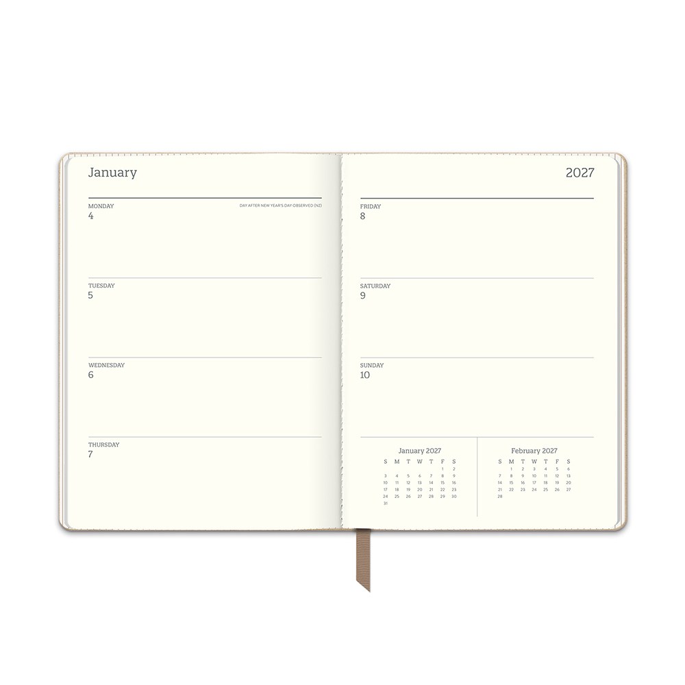 Orange Circle 2027 Medium Dual-Textured Diary 142 x 193mm Week To View Dots On Chai shown from a second angle, the Dots On Chai design, a fine dot on a warm chai neutral, with the spine and page block edge visible.