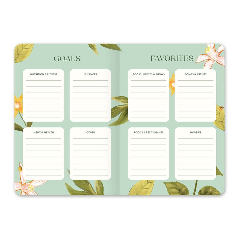 Orange Circle 2027 Monthly Pocket Diary 114 x 165mm Month To View Fruit And Flora shown at a three quarter angle, the Fruit And Flora design, a bright botanical mix of fruit and flowers, highlighting the cover finish and binding edge.